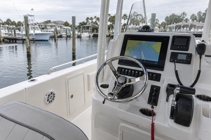 Practical center-console boat helm with navigation equipment in daylight